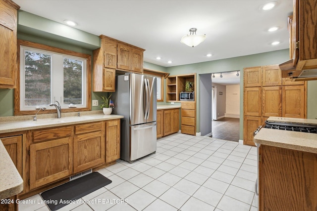 kitchen featuring light tile patterned flooring, sink, and appliances with stainless steel finishes