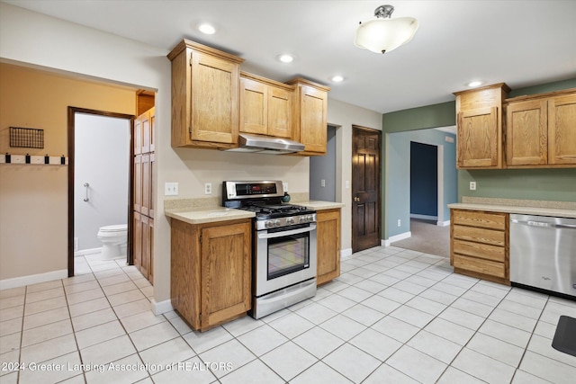 kitchen with appliances with stainless steel finishes and light tile patterned floors