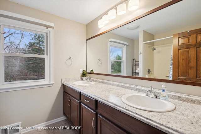 bathroom featuring vanity and  shower combination