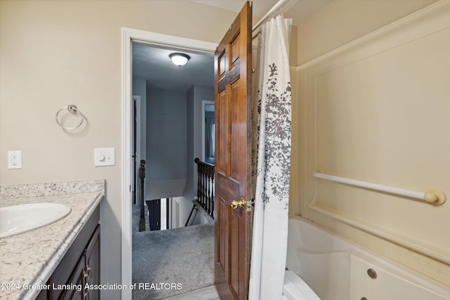 bathroom with shower / tub combo and vanity