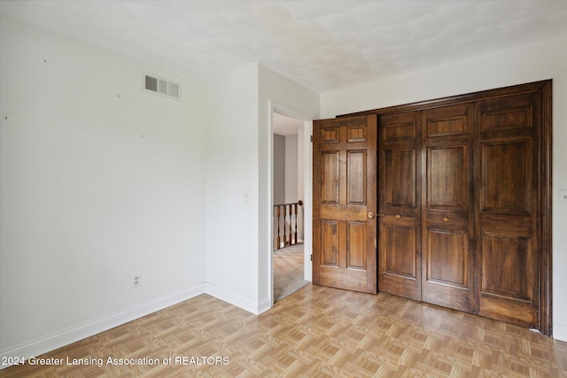 unfurnished bedroom with light parquet flooring