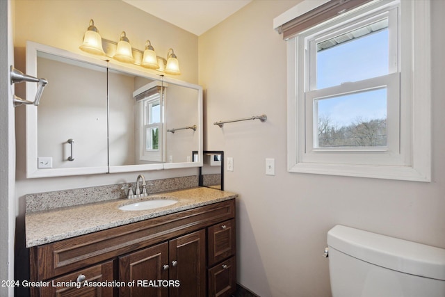 bathroom featuring vanity and toilet