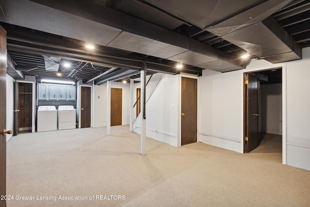 basement featuring carpet and washer and dryer