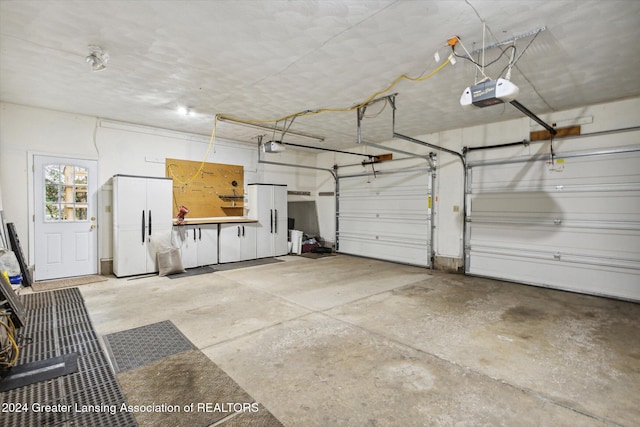 garage featuring a garage door opener and white refrigerator