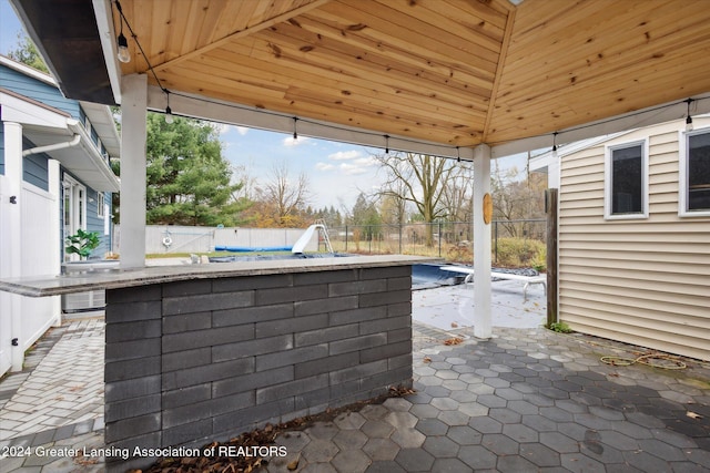 view of patio with a bar and a gazebo