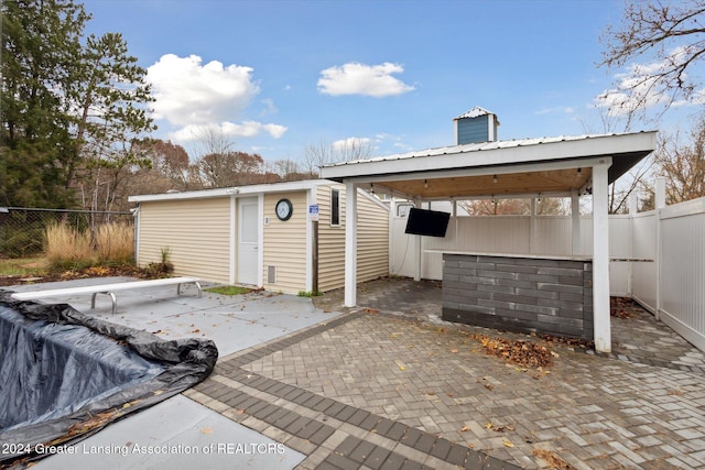 view of patio featuring a shed