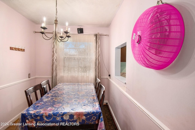 dining space featuring a notable chandelier