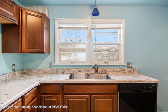 kitchen with hanging light fixtures, sink, and dishwasher