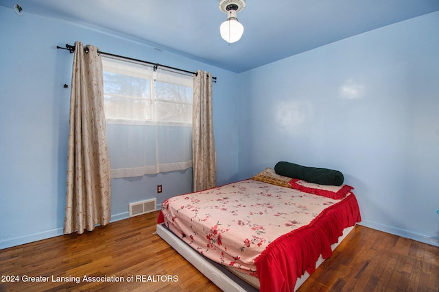 bedroom with hardwood / wood-style flooring