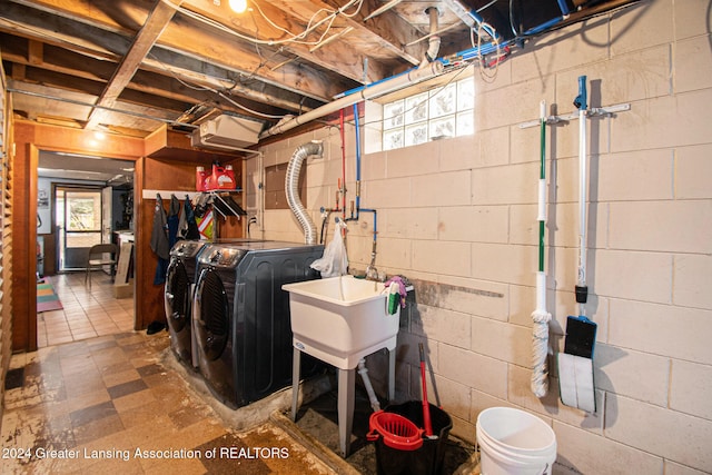 washroom with washer and clothes dryer and sink