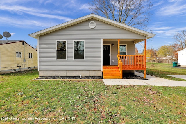 view of front of home with a front yard and covered porch