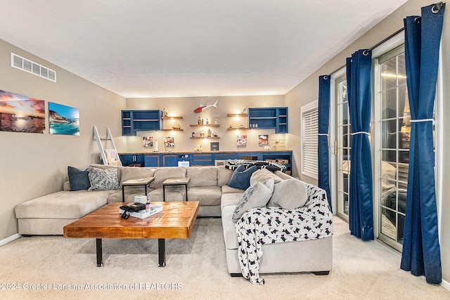 carpeted living room with a textured ceiling