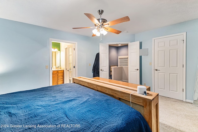 bedroom with carpet, ensuite bath, and ceiling fan