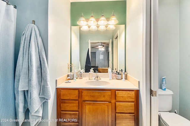 bathroom featuring vanity, ceiling fan, and toilet