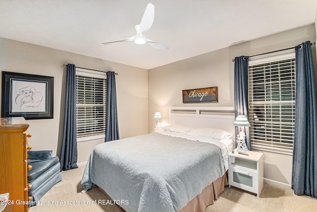 bedroom featuring ceiling fan and light carpet