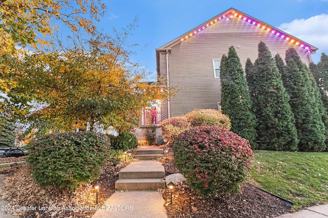 view of home's exterior with a lawn