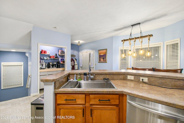 kitchen featuring dishwasher, kitchen peninsula, sink, light tile patterned floors, and pendant lighting