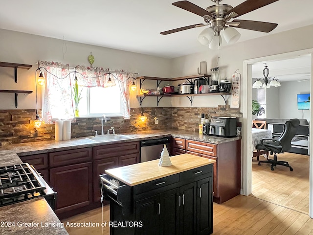 kitchen featuring sink, white range with gas stovetop, dishwasher, light wood-type flooring, and decorative backsplash