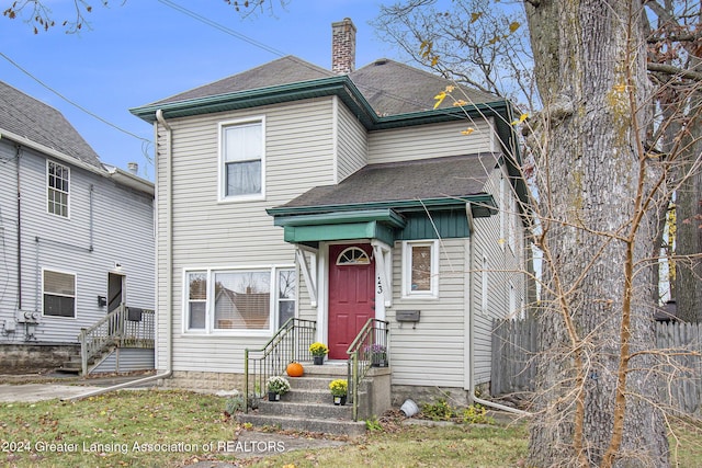 223 S Pennsylvania Ave, Lansing, MI 48912 - view of front of home featuring a chimney and a shingled roof