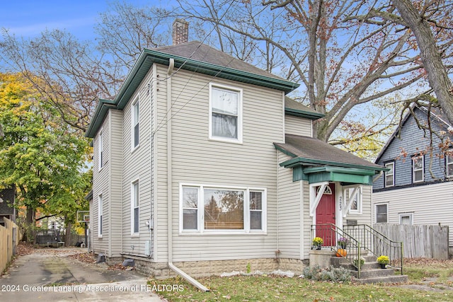 223 S Pennsylvania Ave, Lansing, MI 48912 - view of front of property with fence, a chimney, and a shingled roof