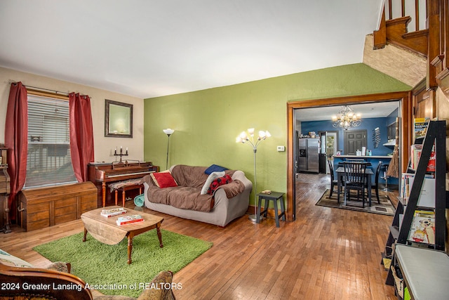 living room featuring wood-type flooring and a notable chandelier