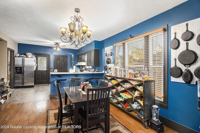 223 S Pennsylvania Ave, Lansing, MI 48912 - dining area with a chandelier, wood-type flooring, ceiling fan, a textured ceiling, and baseboards