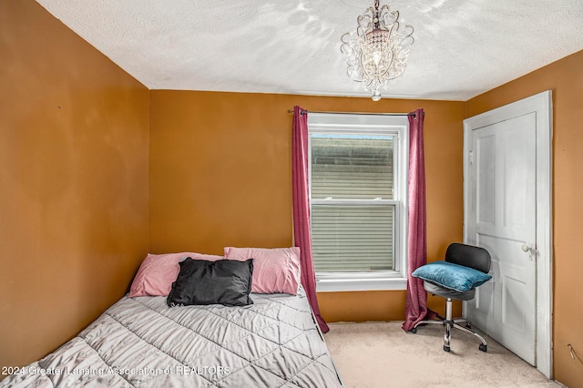 bedroom with a textured ceiling and carpet floors