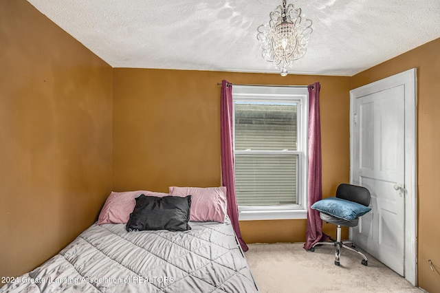 223 S Pennsylvania Ave, Lansing, MI 48912 - bedroom with carpet flooring, a chandelier, and a textured ceiling