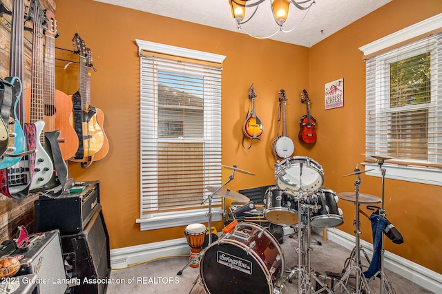 misc room featuring a textured ceiling and a wealth of natural light