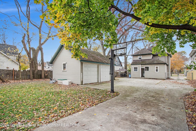 exterior space with a lawn, an outdoor structure, and a garage