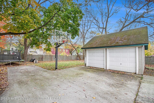 223 S Pennsylvania Ave, Lansing, MI 48912 - detached garage with fence and a trampoline