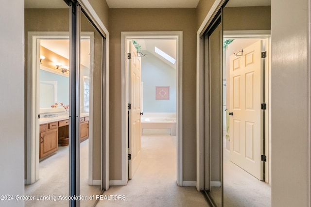 hall featuring light colored carpet