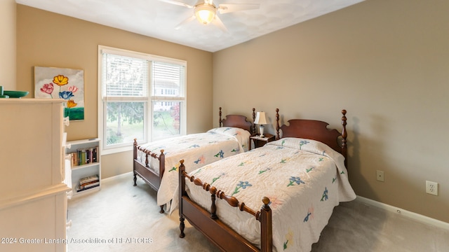 bedroom with light carpet and ceiling fan