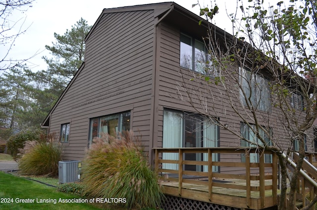 view of property exterior featuring central AC and a deck