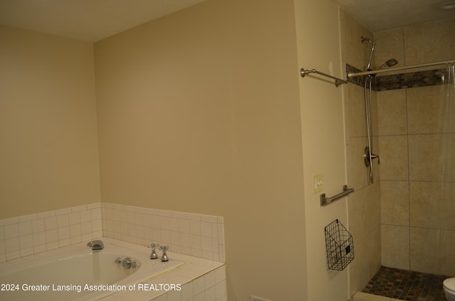 bathroom featuring separate shower and tub and toilet