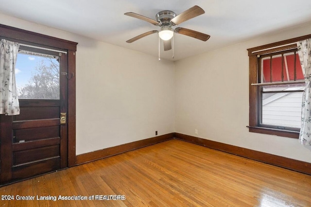 spare room featuring light wood-type flooring and ceiling fan