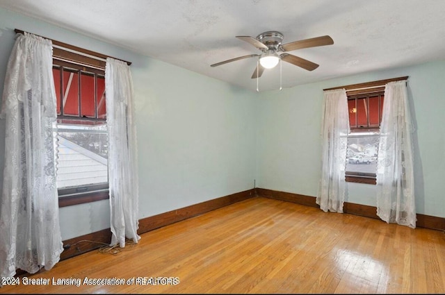 unfurnished room featuring hardwood / wood-style flooring and ceiling fan