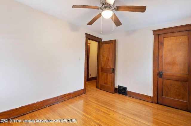 unfurnished bedroom with ceiling fan and light hardwood / wood-style floors