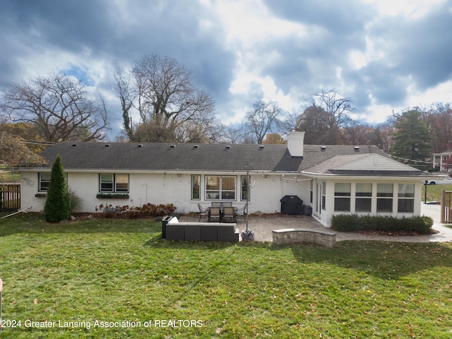 back of property featuring a lawn and a patio area