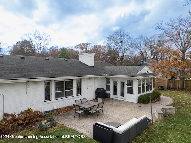 rear view of house featuring a patio and french doors