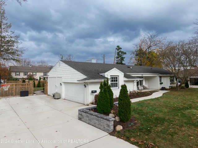 single story home with a front lawn and a garage