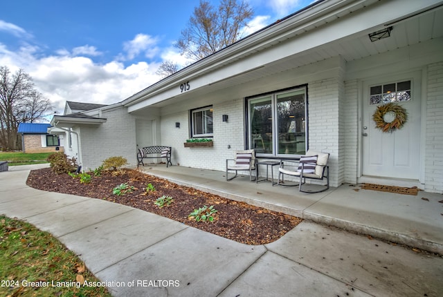 view of exterior entry featuring a porch