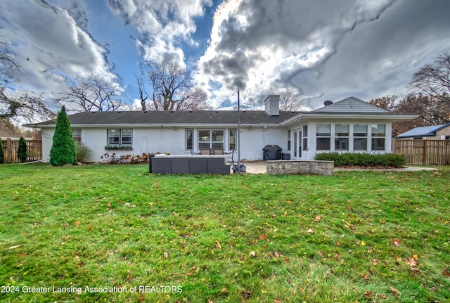 rear view of house featuring a patio and a yard