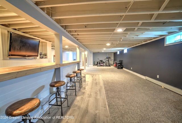 interior space featuring bar and wood-type flooring