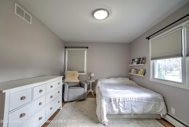 bedroom with a baseboard heating unit