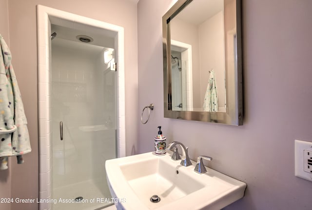 bathroom featuring walk in shower and sink