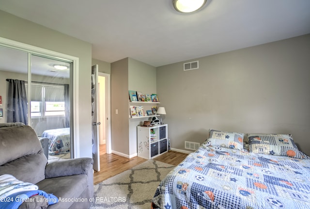 bedroom featuring hardwood / wood-style flooring and a closet