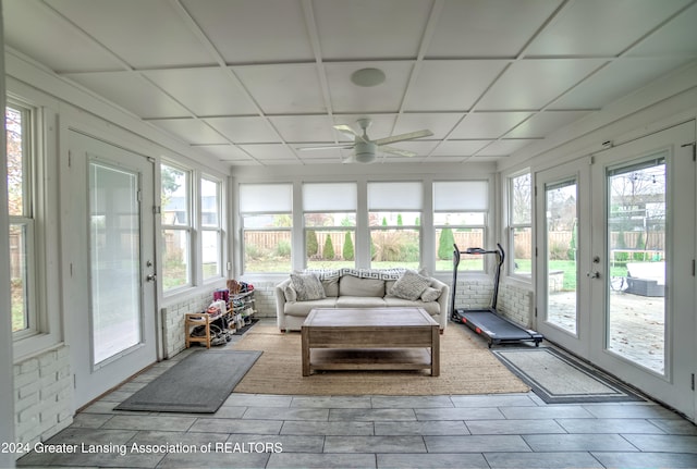 sunroom / solarium with a wealth of natural light, a paneled ceiling, and ceiling fan