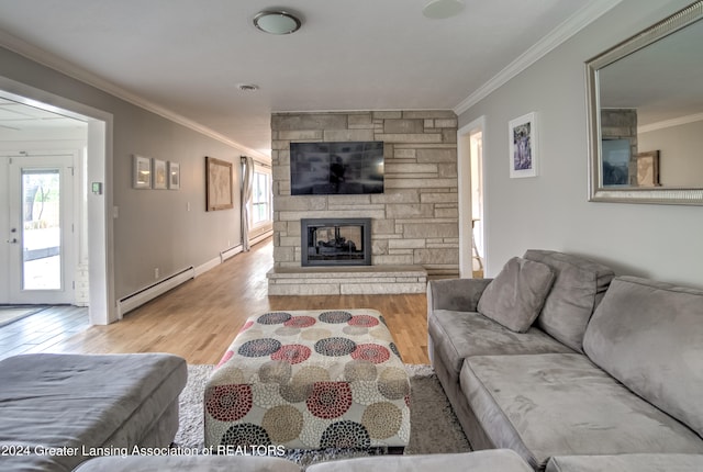 living room featuring french doors, ornamental molding, a fireplace, light hardwood / wood-style floors, and a baseboard heating unit