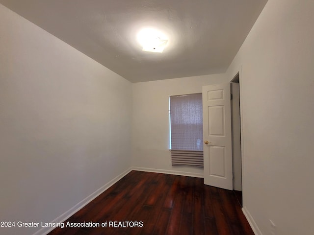 empty room with dark wood-type flooring